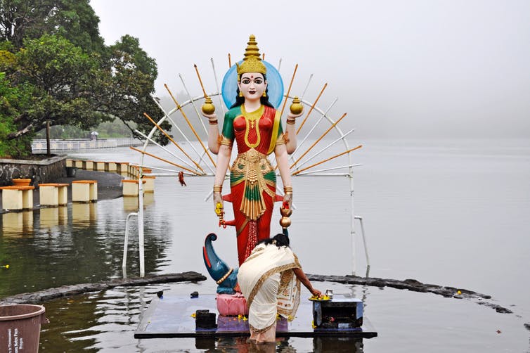Lady giving offerings to a Hindu God.